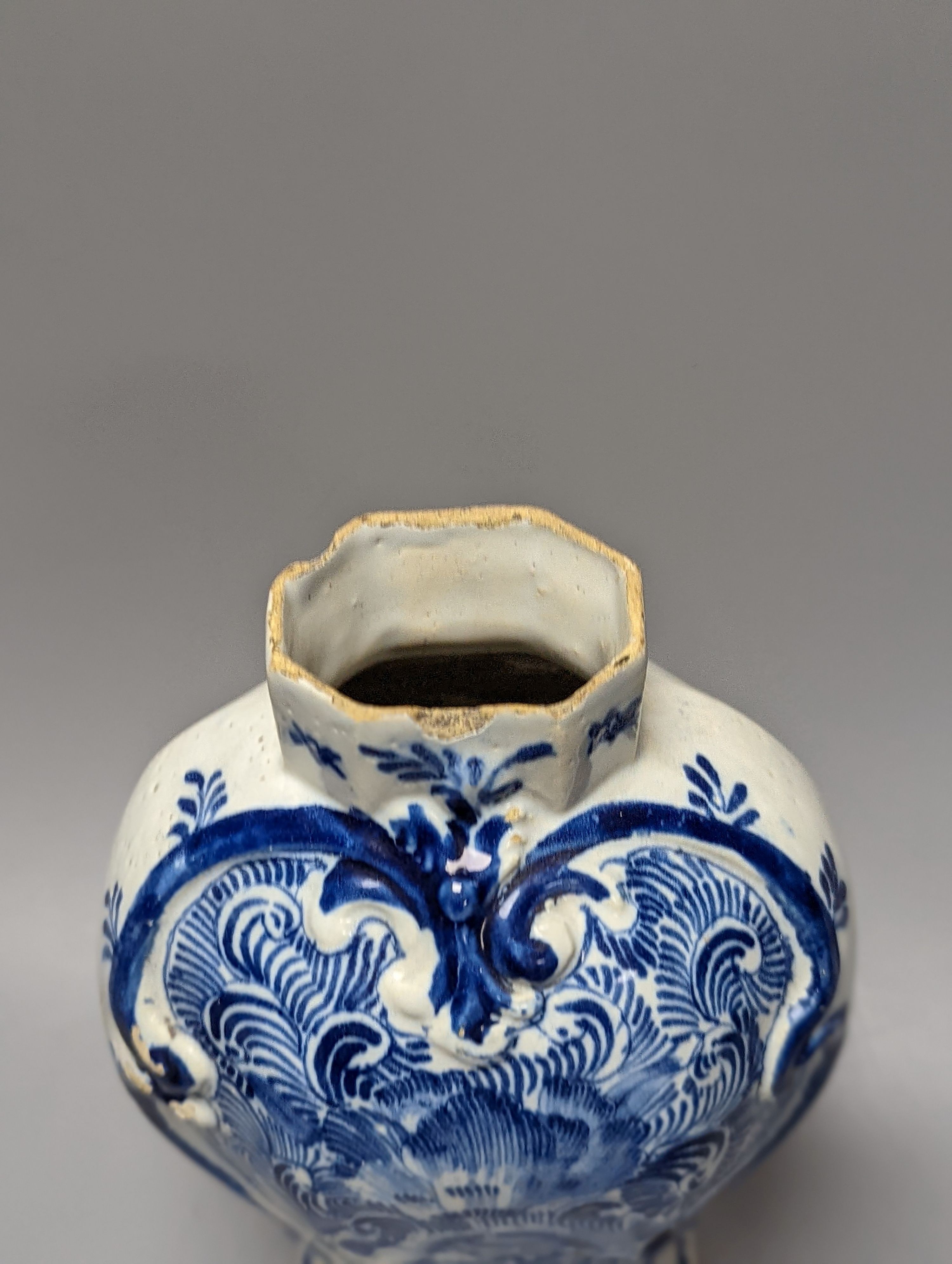 Four items of early 19th century blue and white pearlware pottery, an 18th century Delft blue and white vase and a 19th century toothbrush holder, Delft vase 22 cms high.